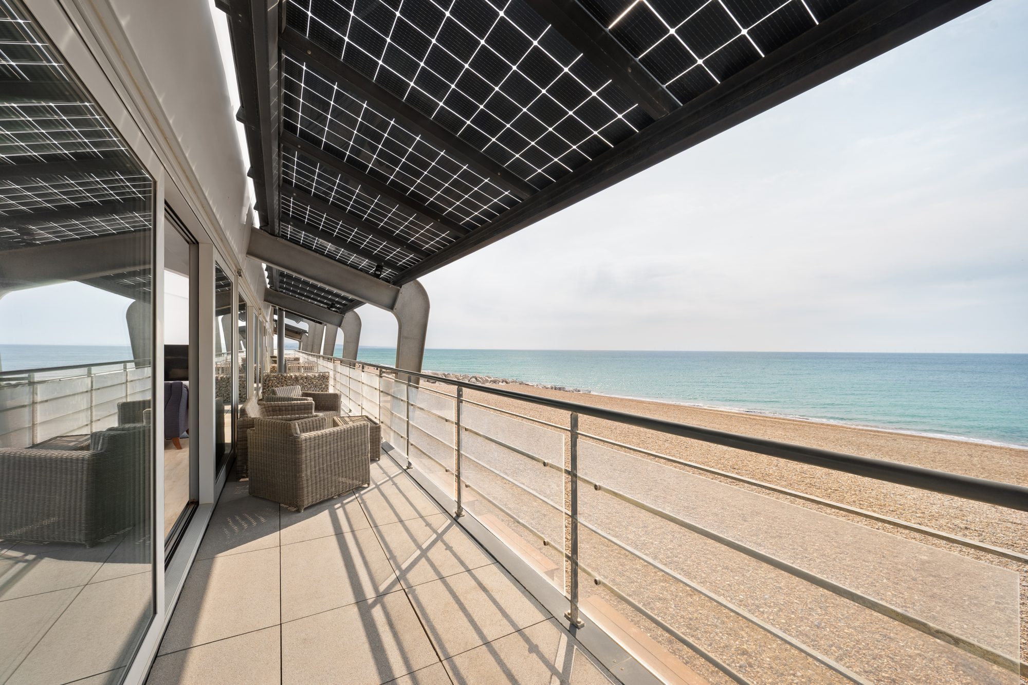 The balcony of a seafront apartment in Lancing, looking along the beach